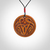 Hand carved natural stained bone contemporary disc pendant with creative and unique carvings on the front face of each individual piece.
